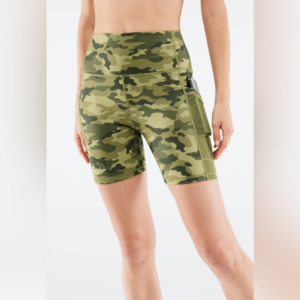 Fabletics Mila High-Waisted Pocket Biker Shorts in a green camouflage print.
